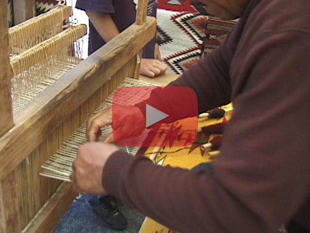 Play button showing weaver using loom