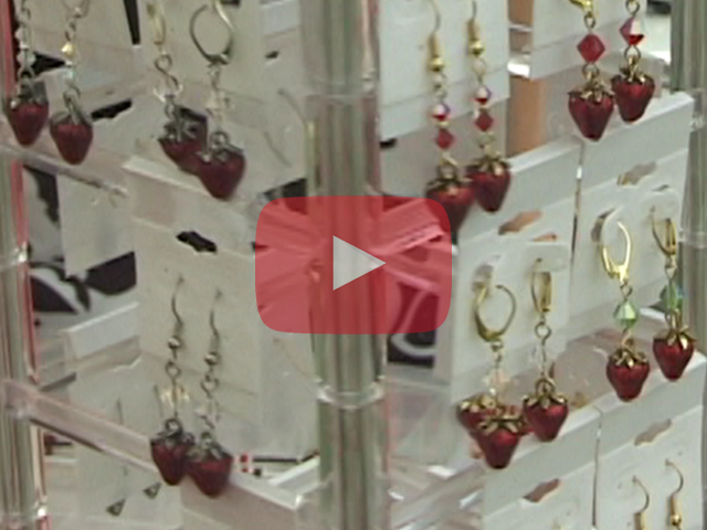 Play button showing strawberry jewelry display